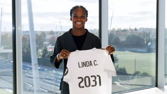 Linda Caicedo sostiene una camiseta con la renovación hasta 2031