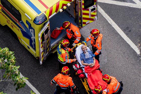 Los equipos de rescate suben a una ambulancia a una persona herida en el incendio en el distrito Tai Po de Hong Kong, China